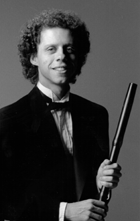 Lars in tuxedo, 
holding cool looking 18th century flute